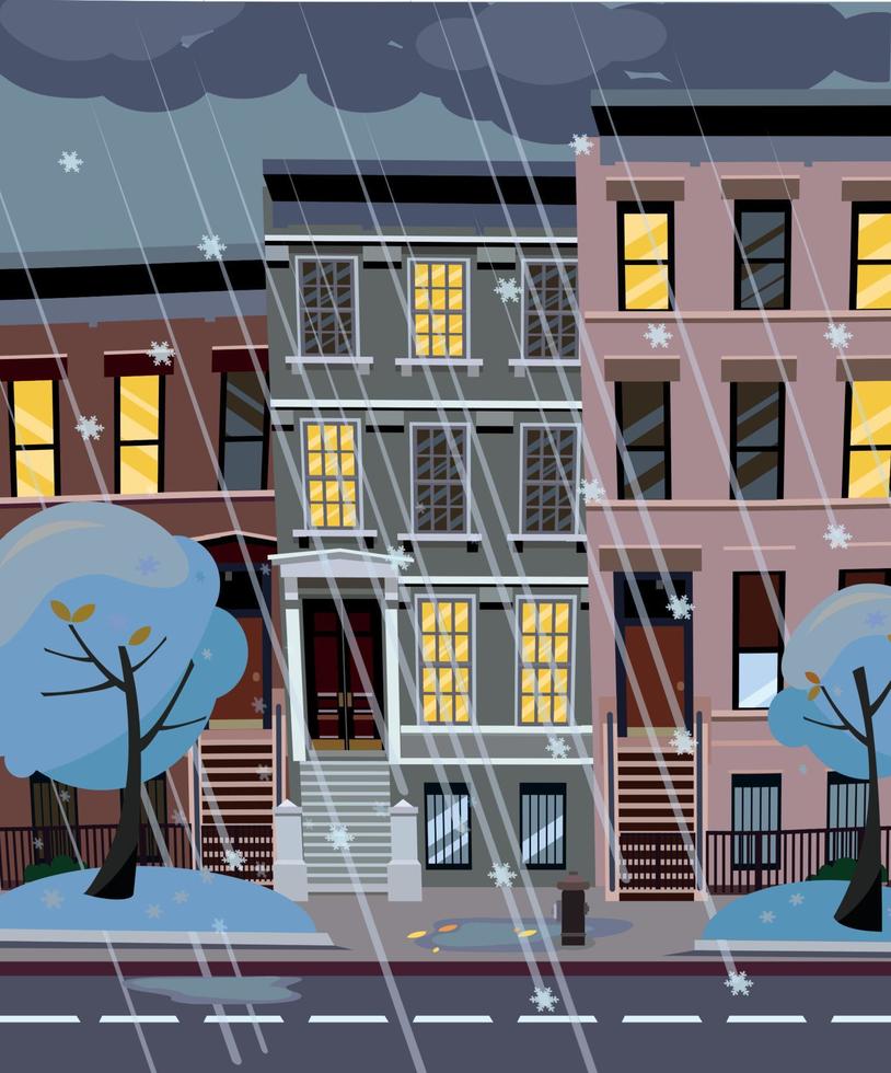 Flat cartoon vector illustration of winter snowy city street at night. 3-4-story uneven houses with luminous windows,. Street cityscape. Evening town landscape with trees in the foreground, puddles