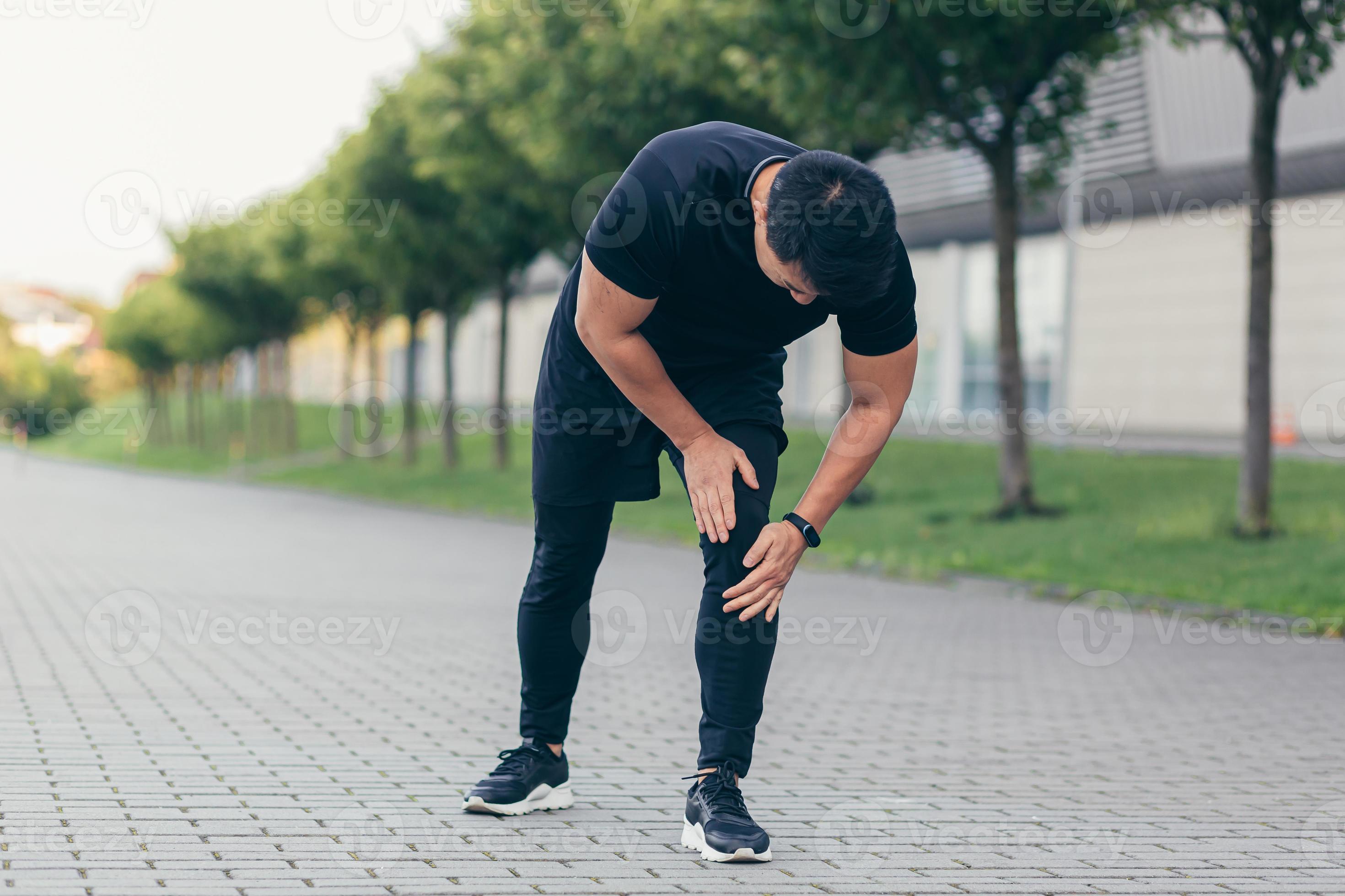 Asian man holding knee pain after running and fitness, severe leg pain