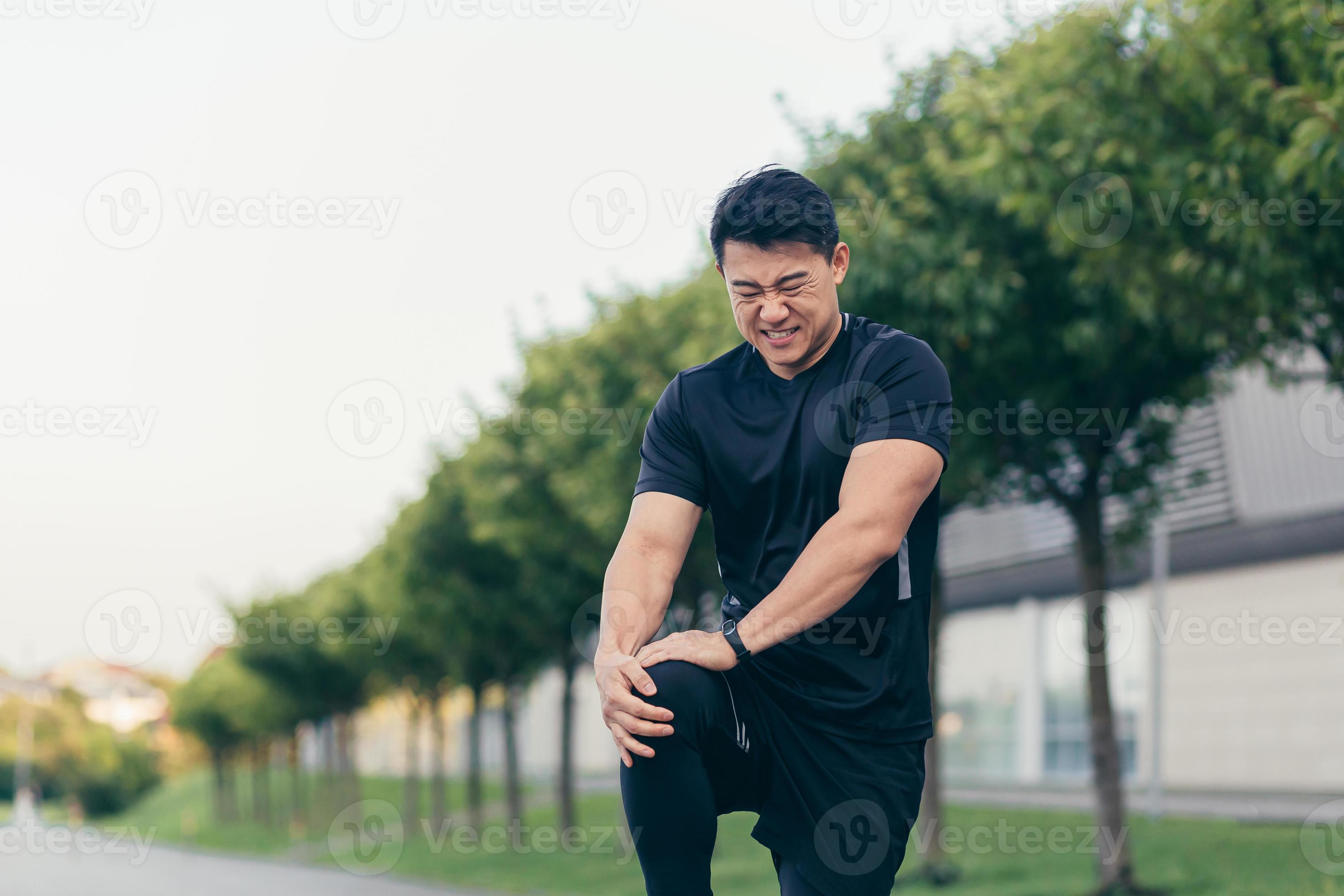 Asian man holding knee pain after running and fitness, severe leg pain 12495302 Stock Photo at