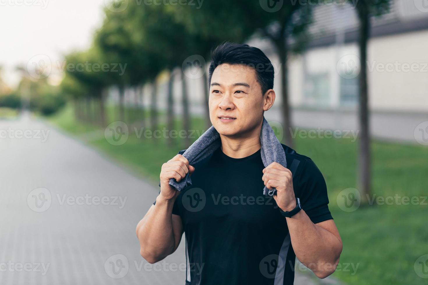 asian man after fitness workout and jogging happy man smiling shows thumb up and looks at camera photo