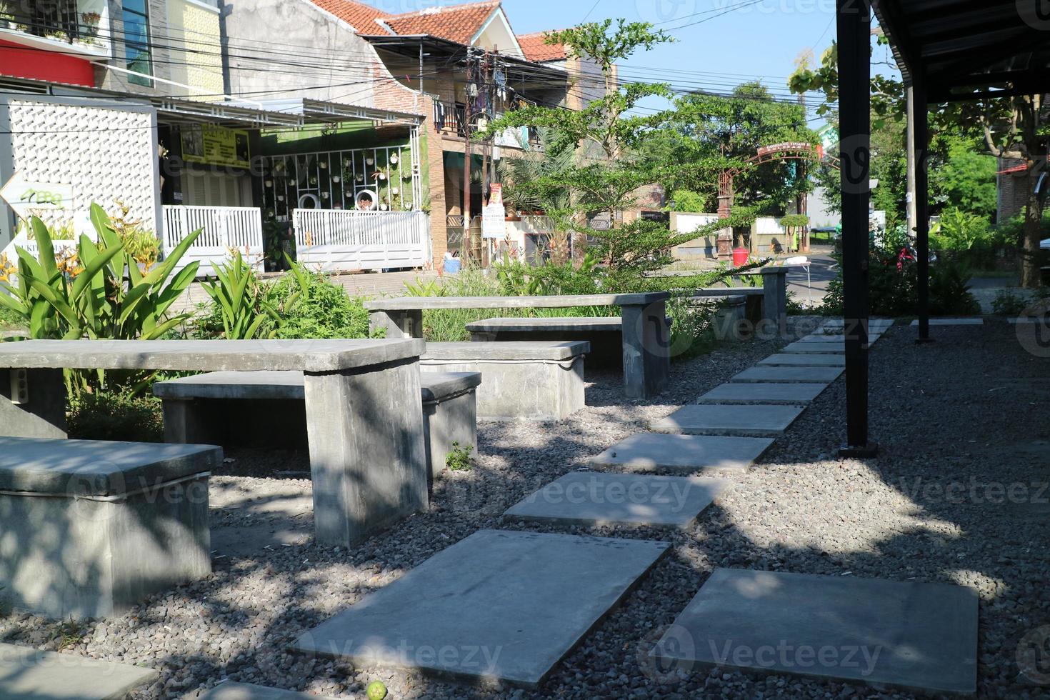 table and chairs made of cement on the side of the road photo