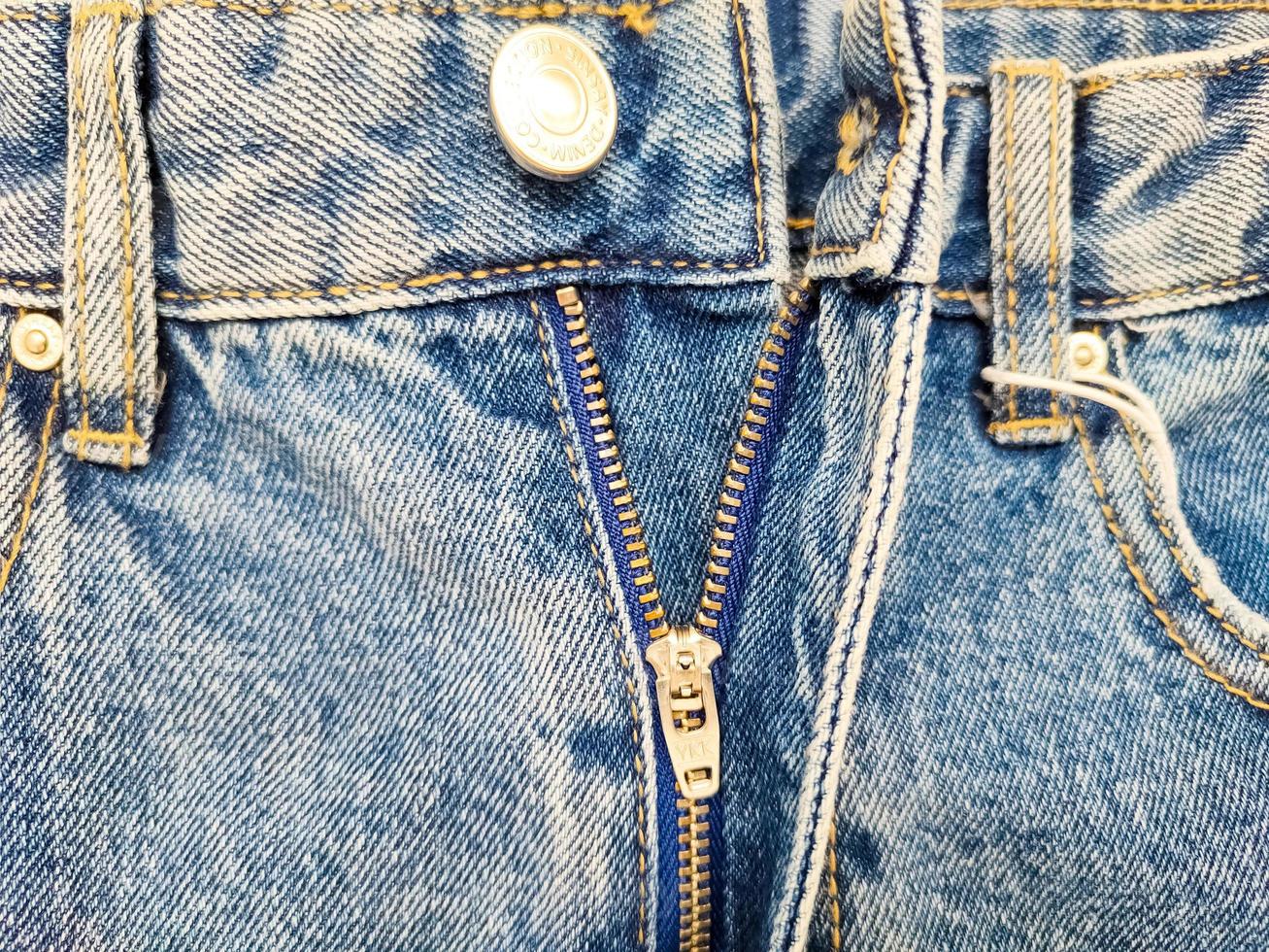 Zipper on jeans. Jeans texture. Unzipped jeans. photo