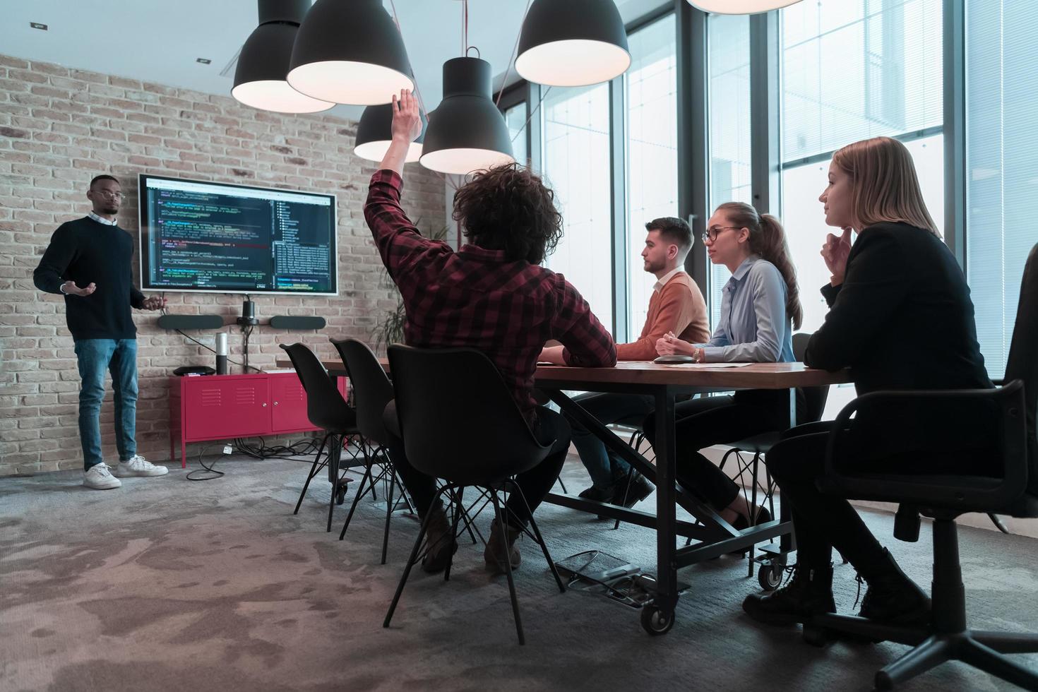 Leader give a business presentation at an office conference meeting, businessman coach mentor explains graph chart on board corporate group workshop training in boardroom. Selective focus photo
