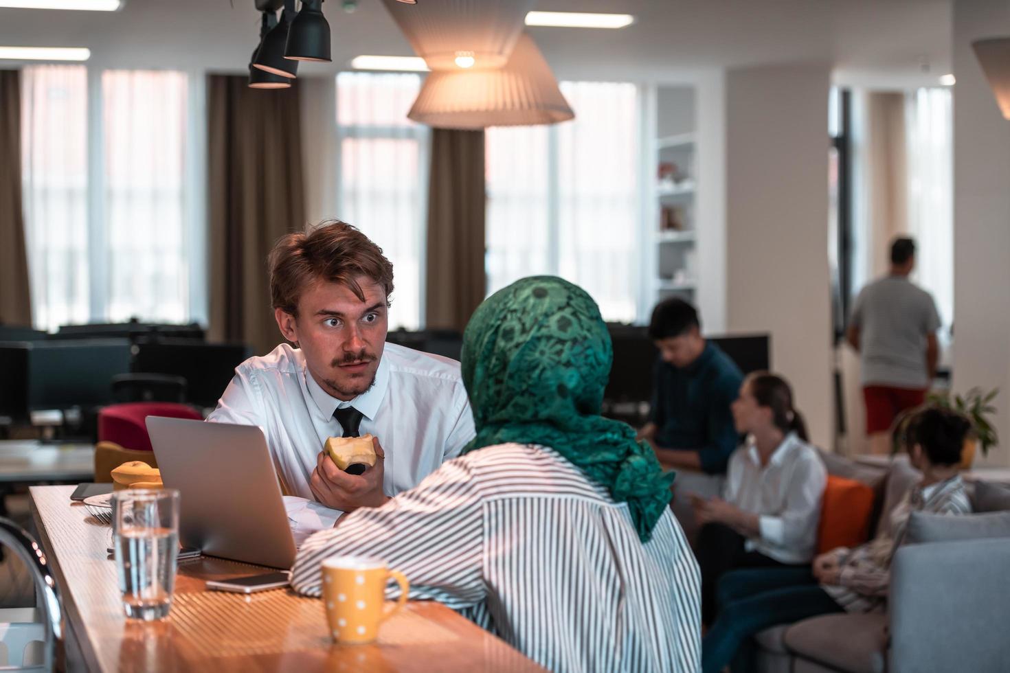 International multicultural business team.A young business man and woman sit in a modern relaxation space and talk about a new business. photo