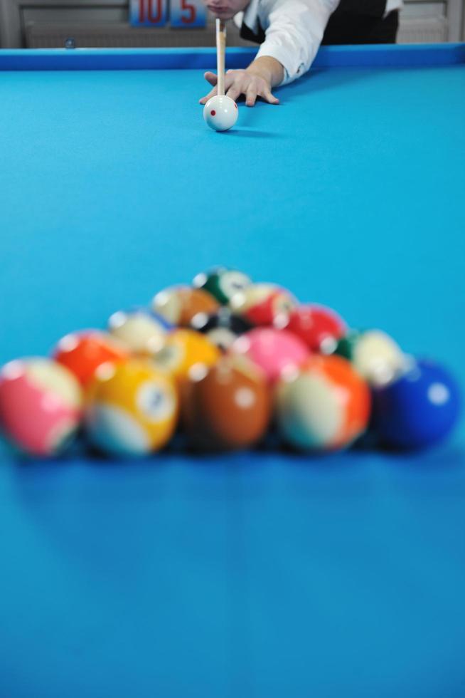 young man play pro billiard game photo