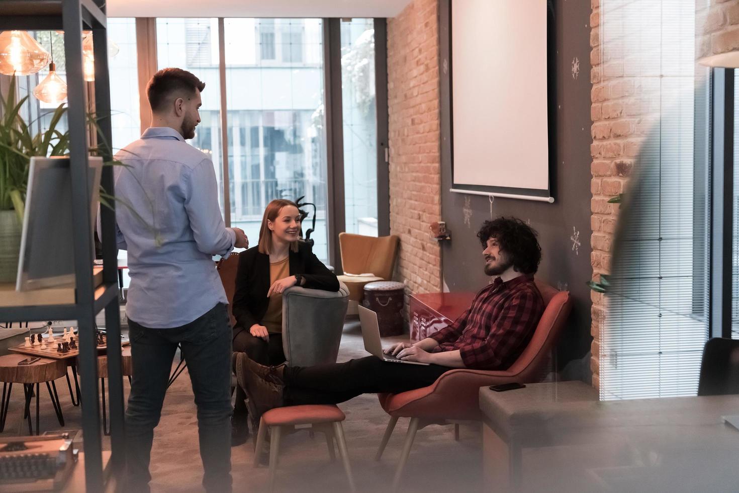Successful team. Group of young business people working and communicating together in creative office. Selective focus photo