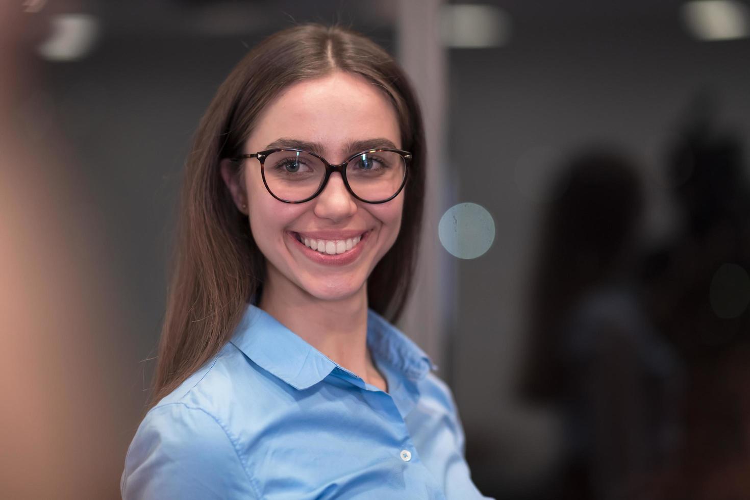 Portrait of freelancer standing in co-working space. Confident businesswoman looking at camera. photo