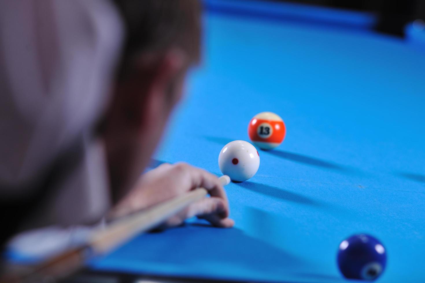 young man play pro billiard game photo
