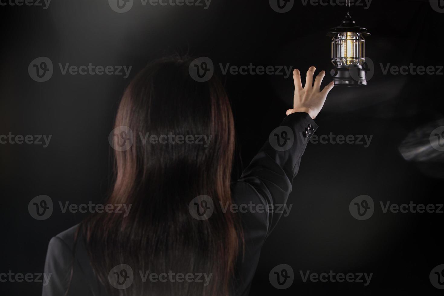 Depressed sad business woman looking and grab light lamp, feeling lonely tired and worried suffering depression in mental health, loneliness and isolation concept. Low key copy space photo