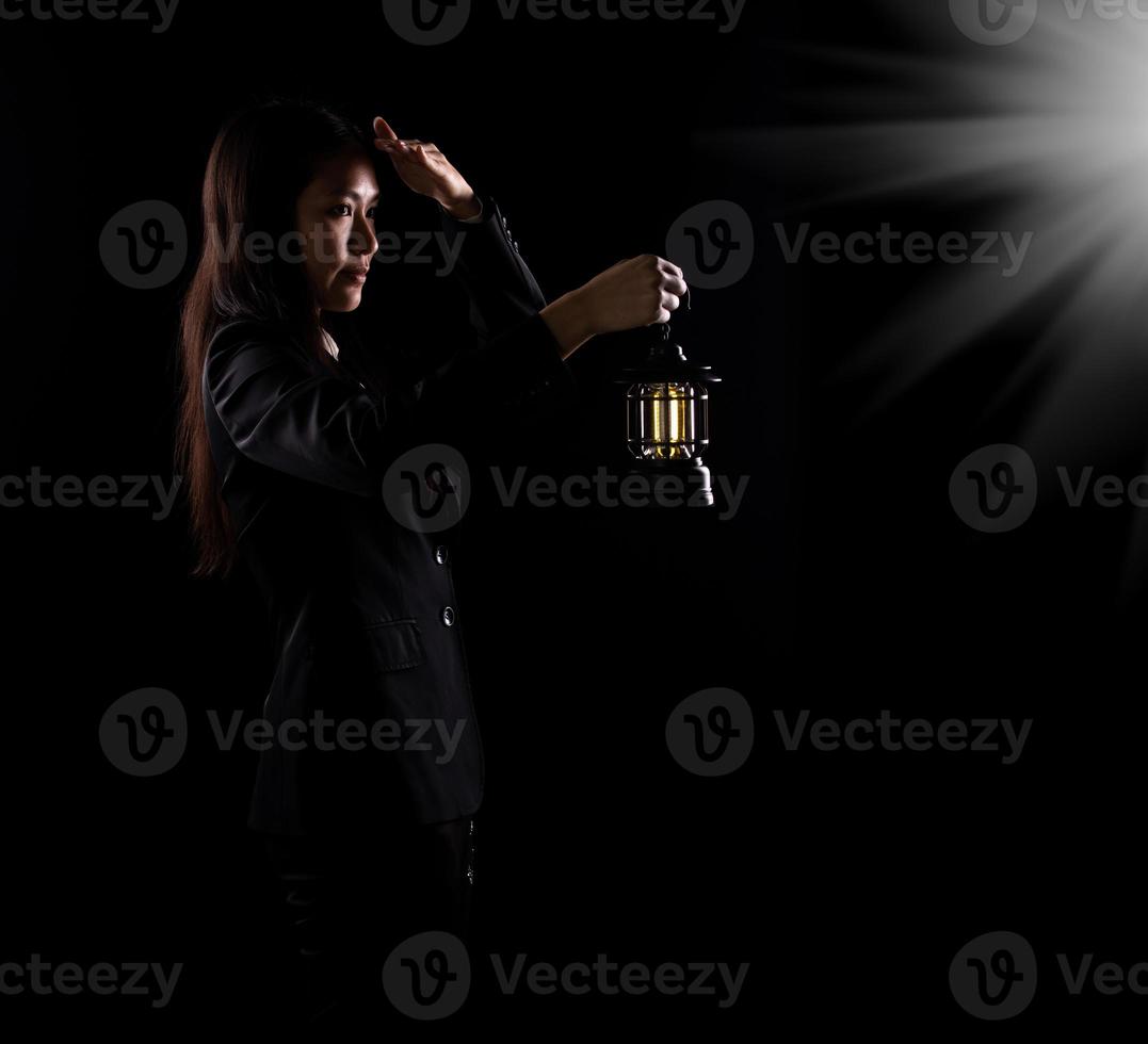 Business Woman hold light lamp lantern as lead the way out of problem, idea solution creativity inspire innovation success glowing your imagination invention. Concept Vision exit, copy space photo