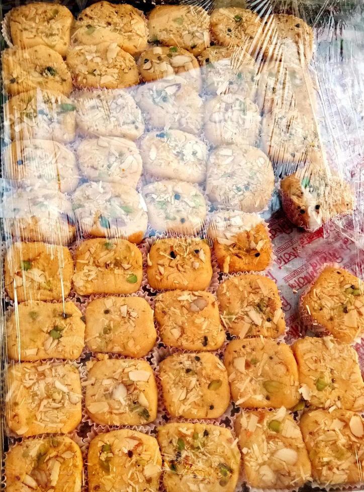 A close-up of nicely arranged colorful sweets in a city commercial shop. photo