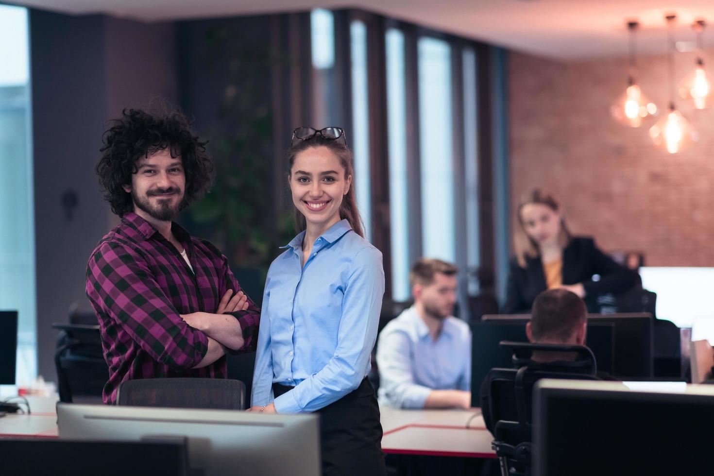 Two happy diverse professional executive business team people woman and man looking at camera standing in office lobby hall. Multicultural company managers team portrait. photo
