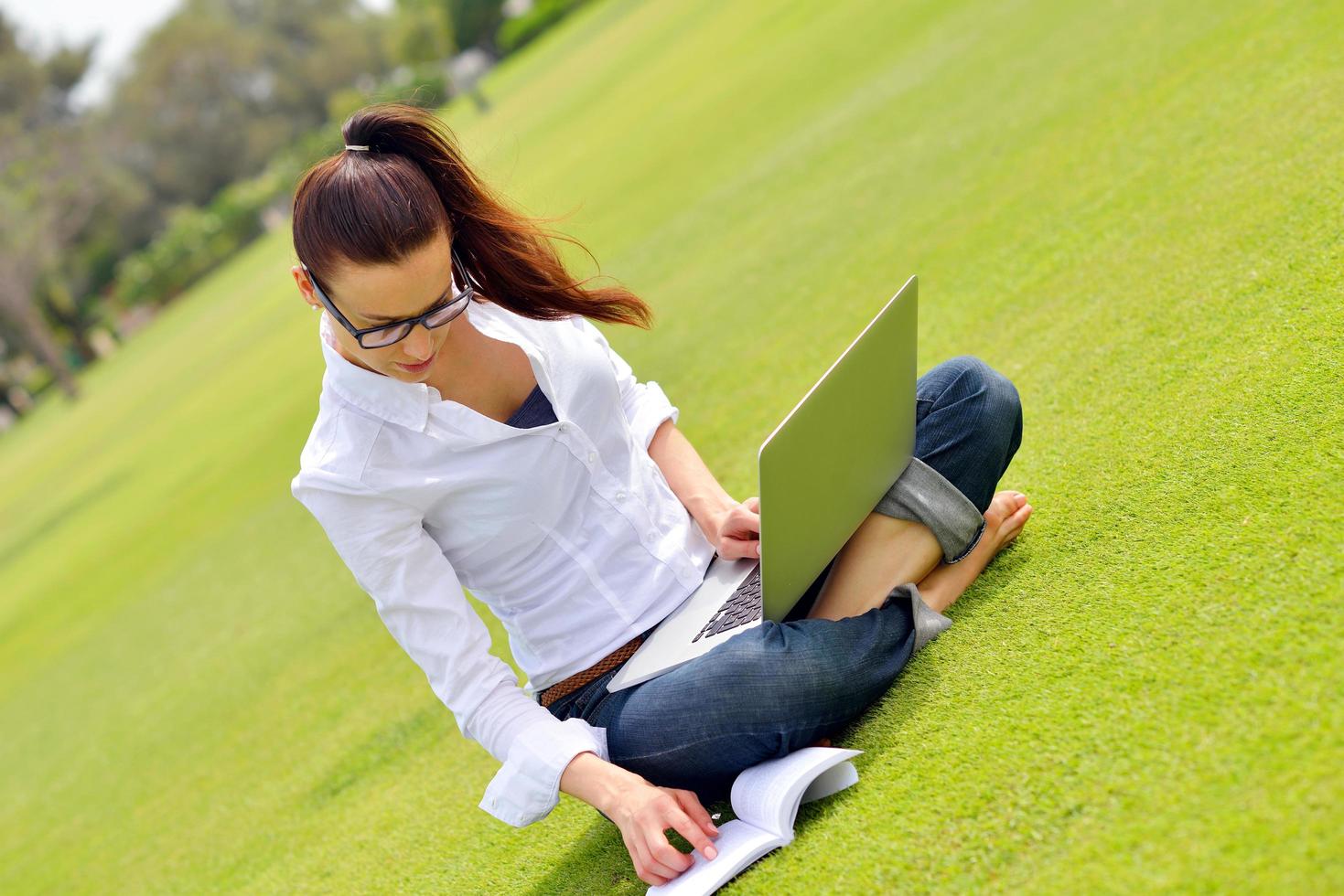 woman with laptop in park photo