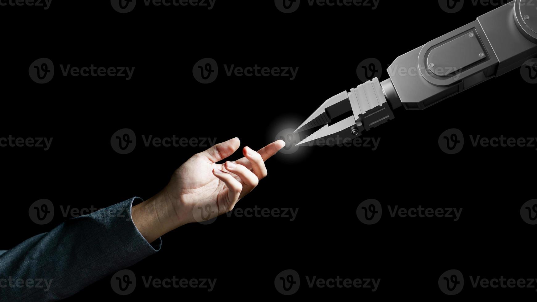 Robot arm and human hand touch like  Adam sign isolated on black background. Concept of togetherness photo