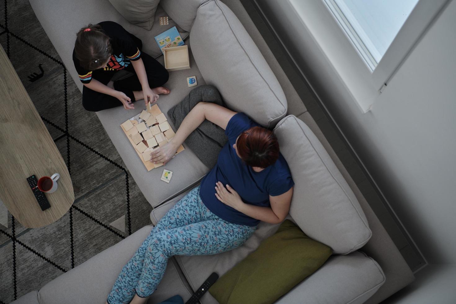 mother and daughter at home playing memory game photo