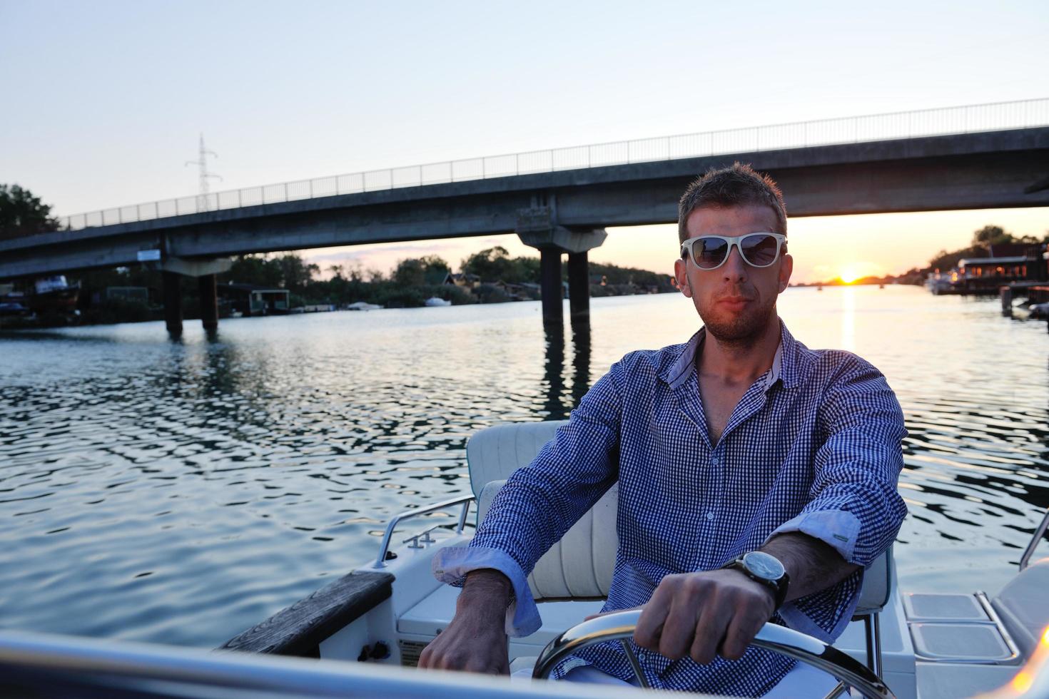 portrait of happy young man on boat photo