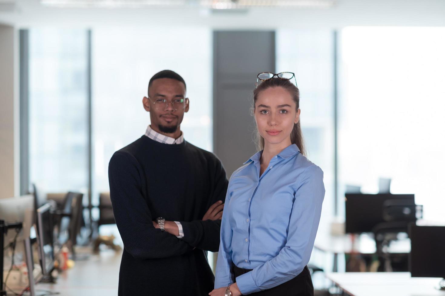 Two happy diverse professional executive business team people woman and African American man looking at camera standing in office lobby hall. Multicultural company managers team portrait. photo