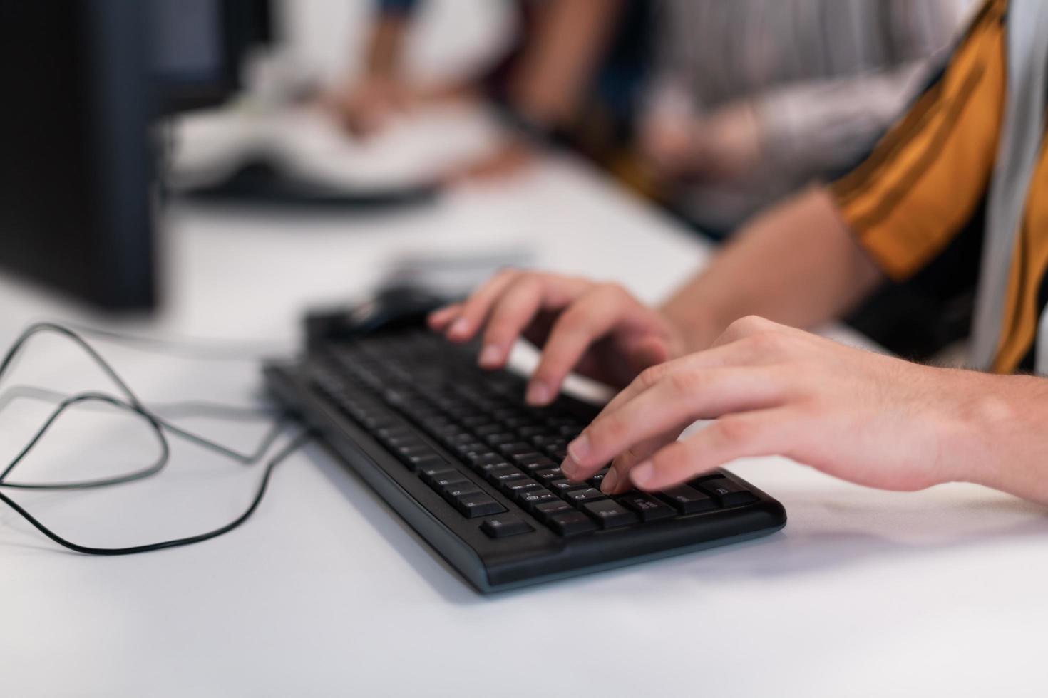 Close up programmer man hand typing on keyboard at desktop pc to input code language into software for study bug and defect of system at office for development of cyber security technology concept photo