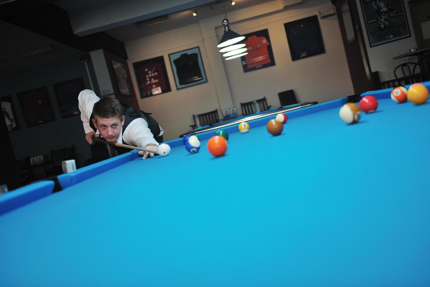 young man play pro billiard game photo