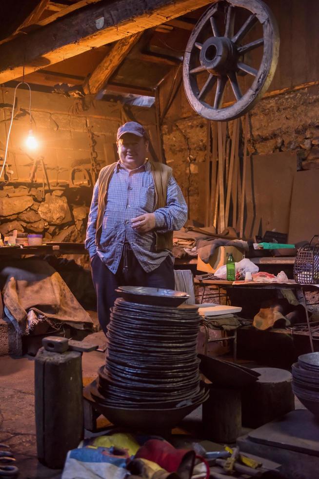 portrait of confident senior blacksmith photo