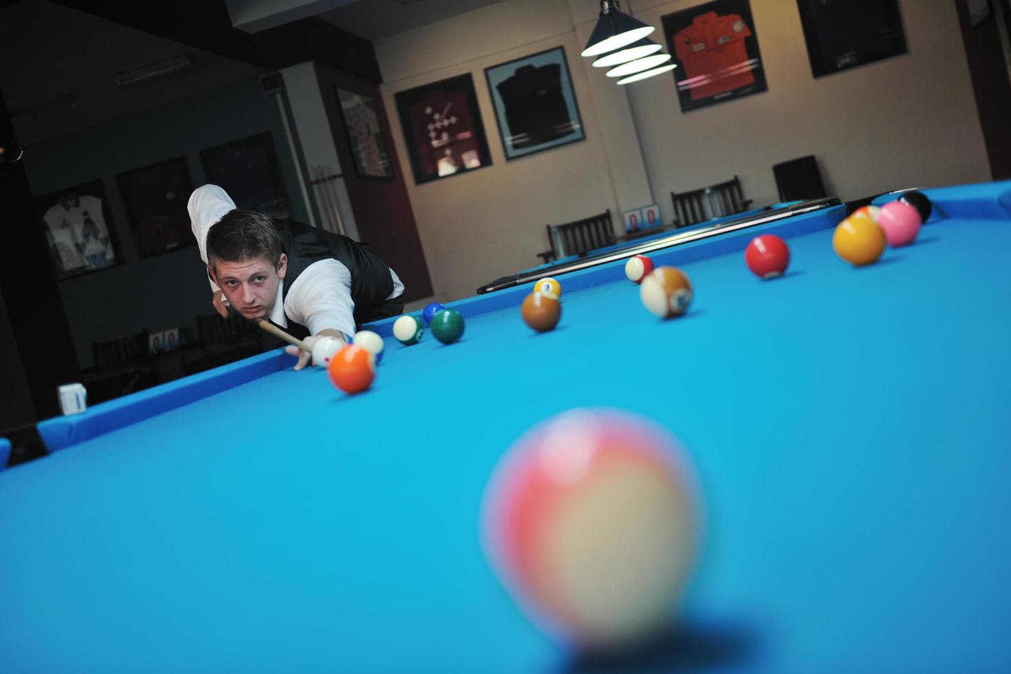 young man play pro billiard game photo