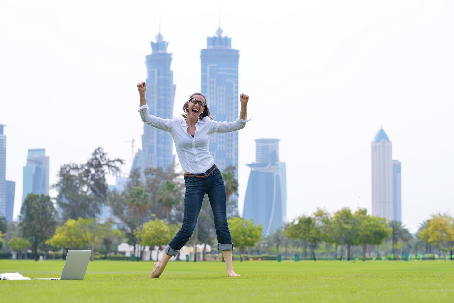 woman with laptop in park photo