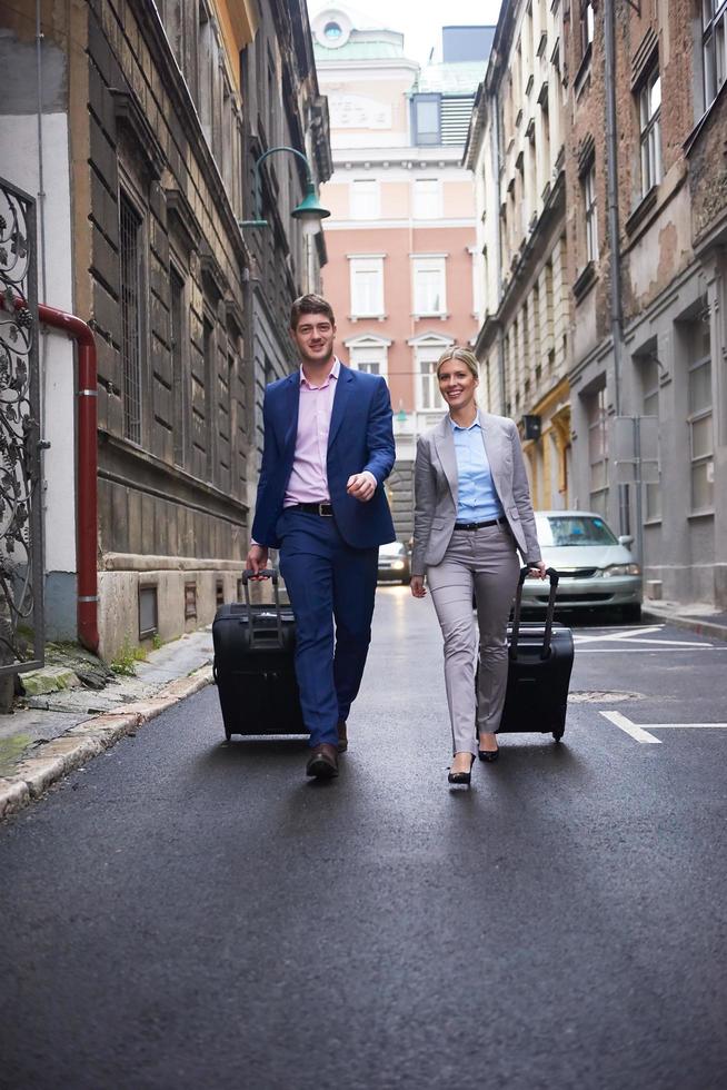 business people couple entering  hotel photo