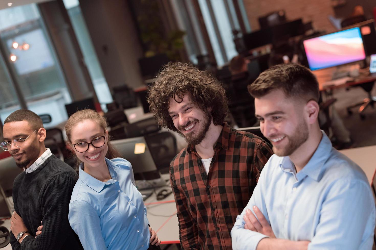 Portrait of successful creative business team looking at camera and smiling. Diverse business people standing together at startup. Selective focus photo