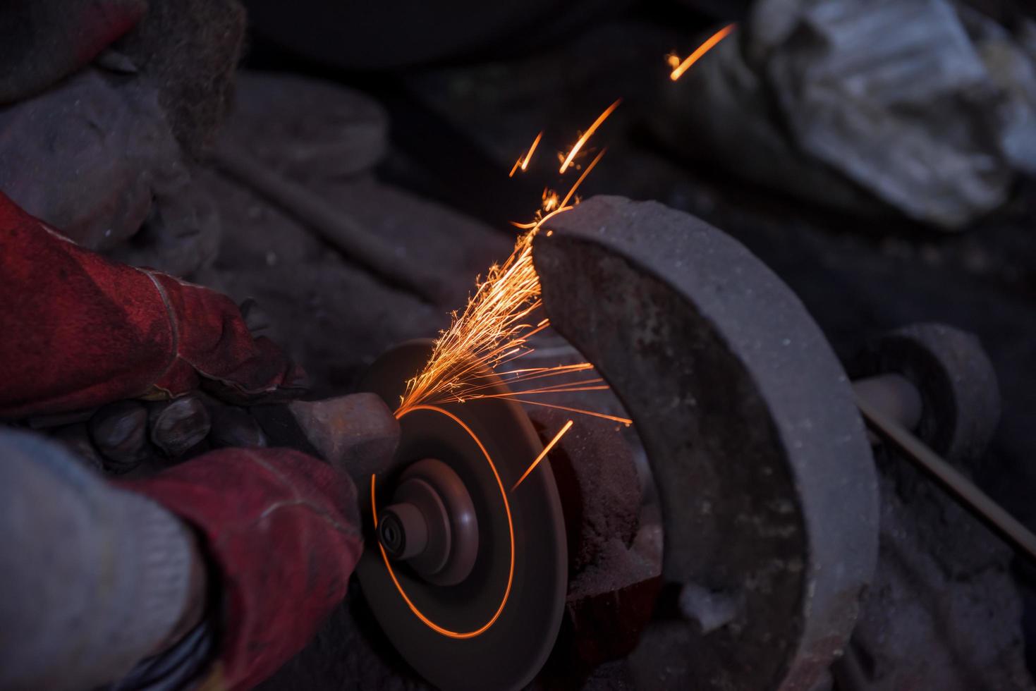 the blacksmith polishing metal products photo