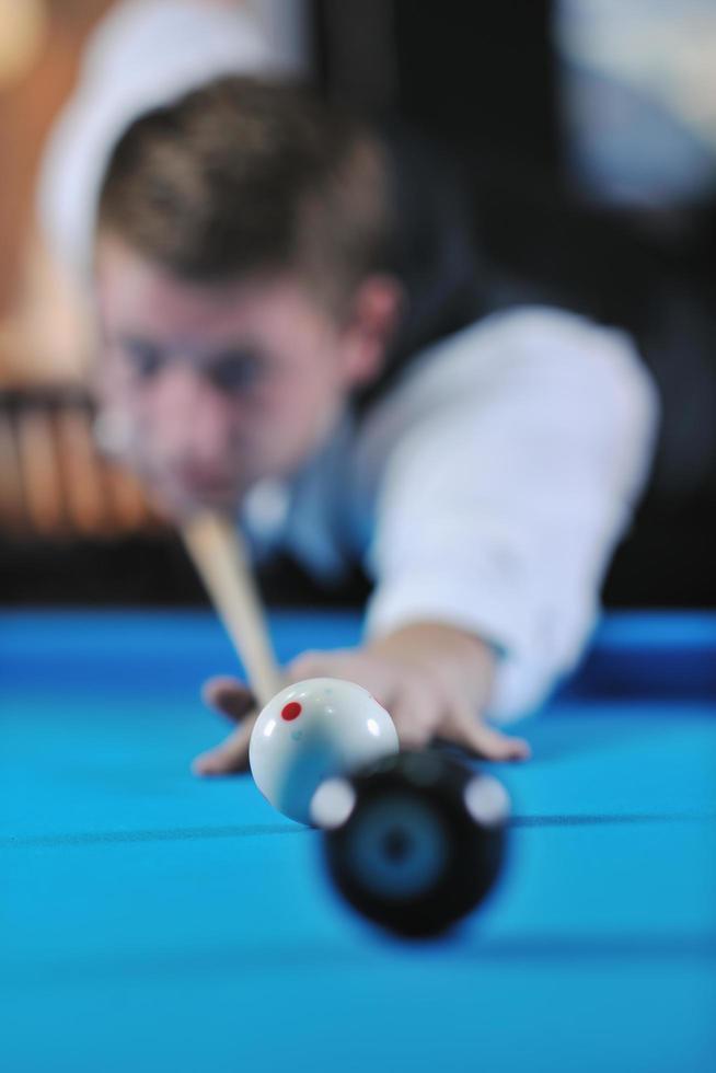 young man play pro billiard game photo