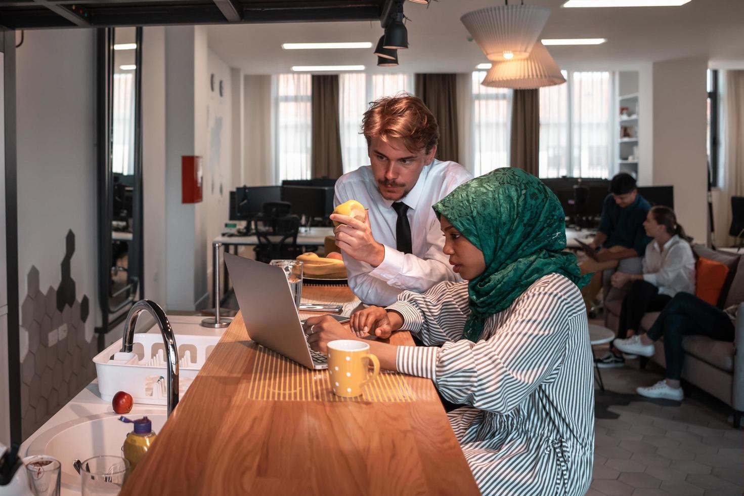 International multicultural business team.A young business man and woman sit in a modern relaxation space and talk about a new business. photo
