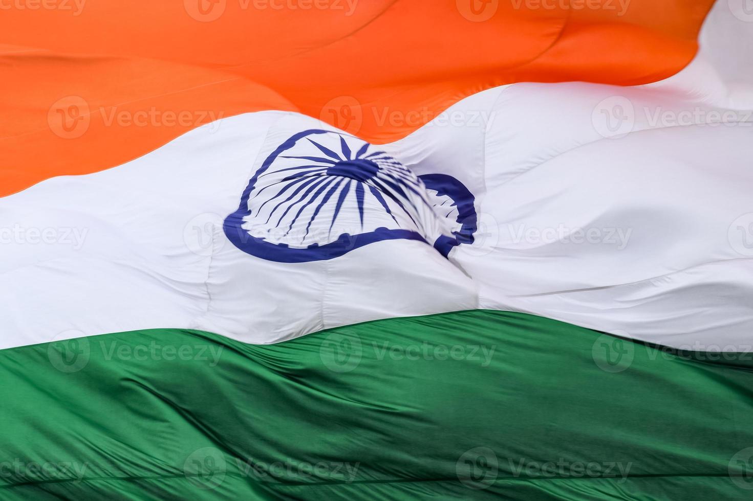 India flag flying high at Connaught Place with pride in blue sky, India flag fluttering, Indian Flag on Independence Day and Republic Day of India, tilt up shot, Waving Indian flag, Har Ghar Tiranga photo