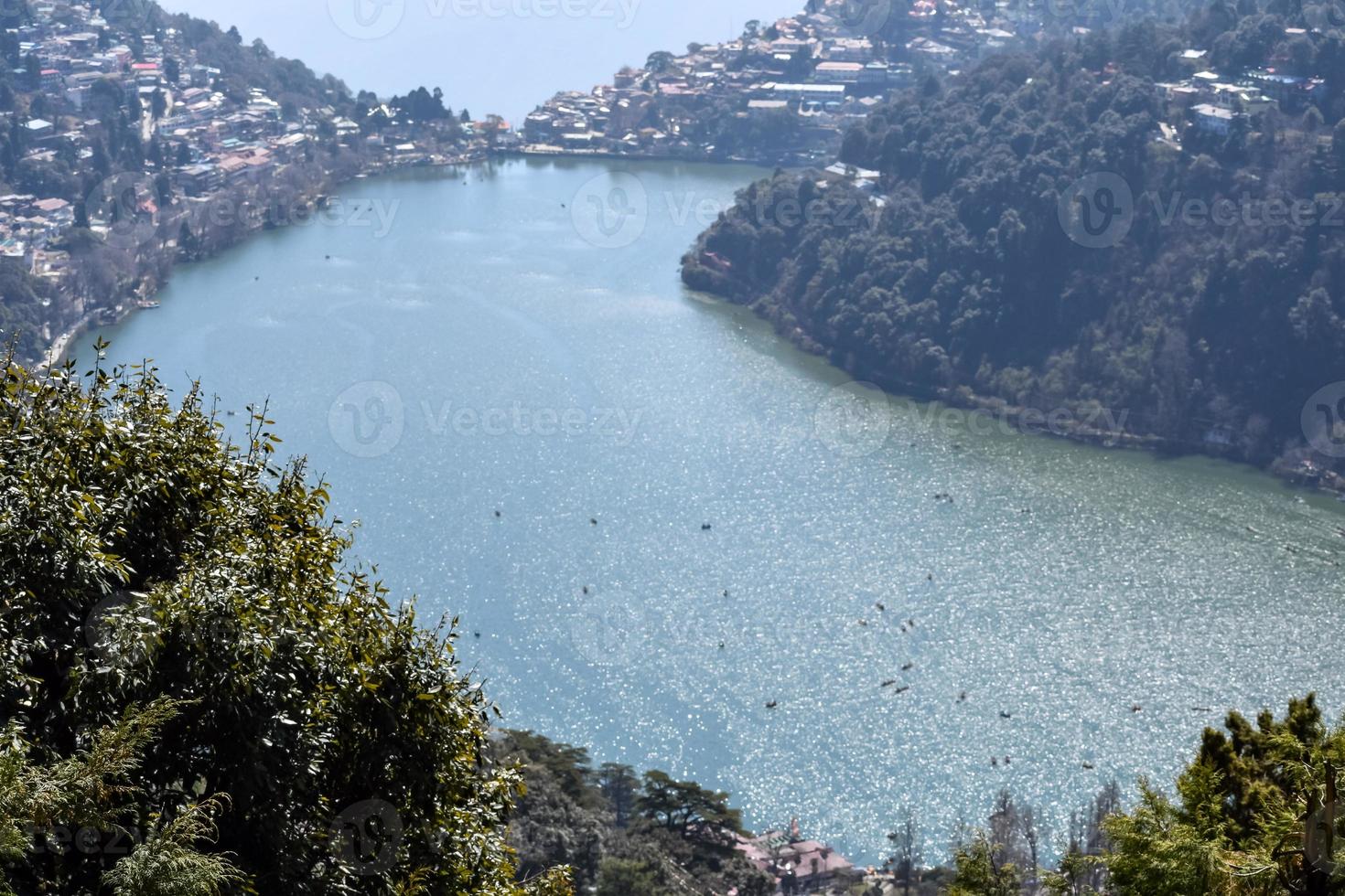 Full view of Naini Lake during evening time near Mall Road in Nainital, Uttarakhand, India, Beautiful view of Nainital Lake with mountains and blue sky photo