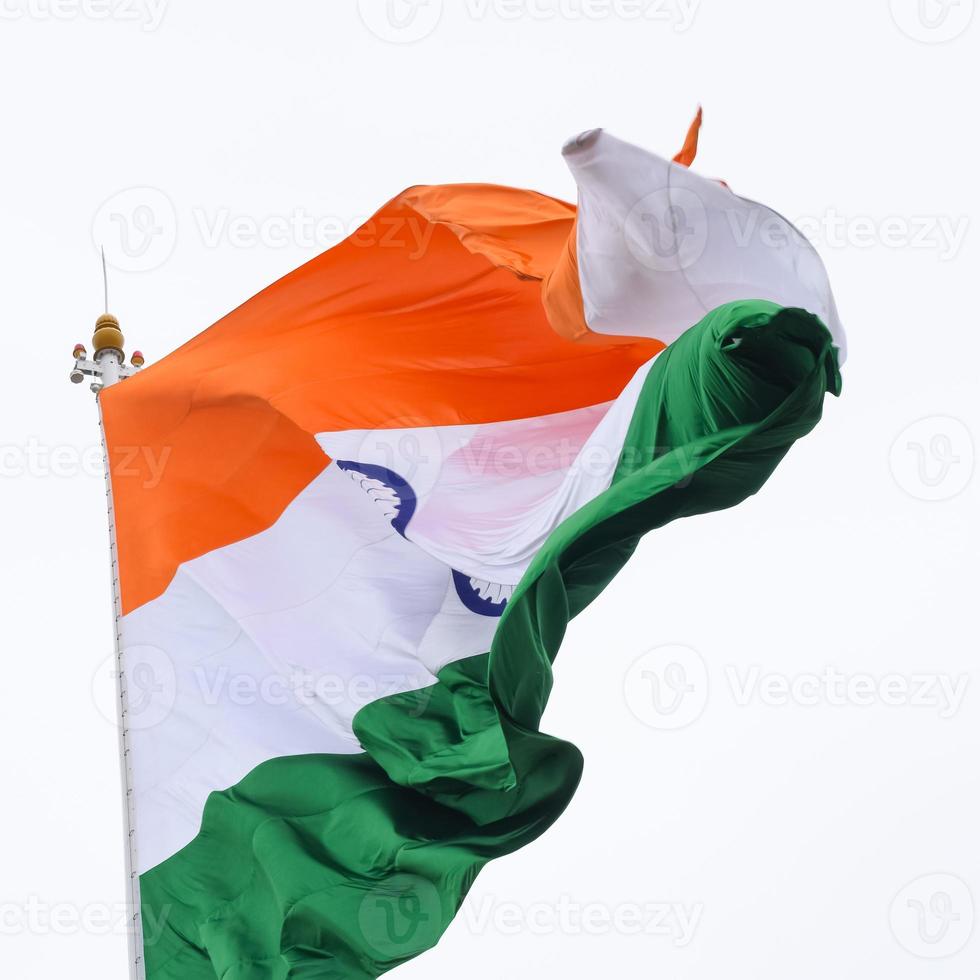 India flag flying high at Connaught Place with pride in blue sky, India flag fluttering, Indian Flag on Independence Day and Republic Day of India, tilt up shot, Waving Indian flag, Har Ghar Tiranga photo