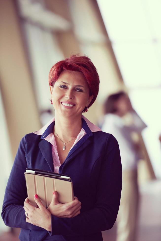 business woman  at office with tablet  in front  as team leader photo