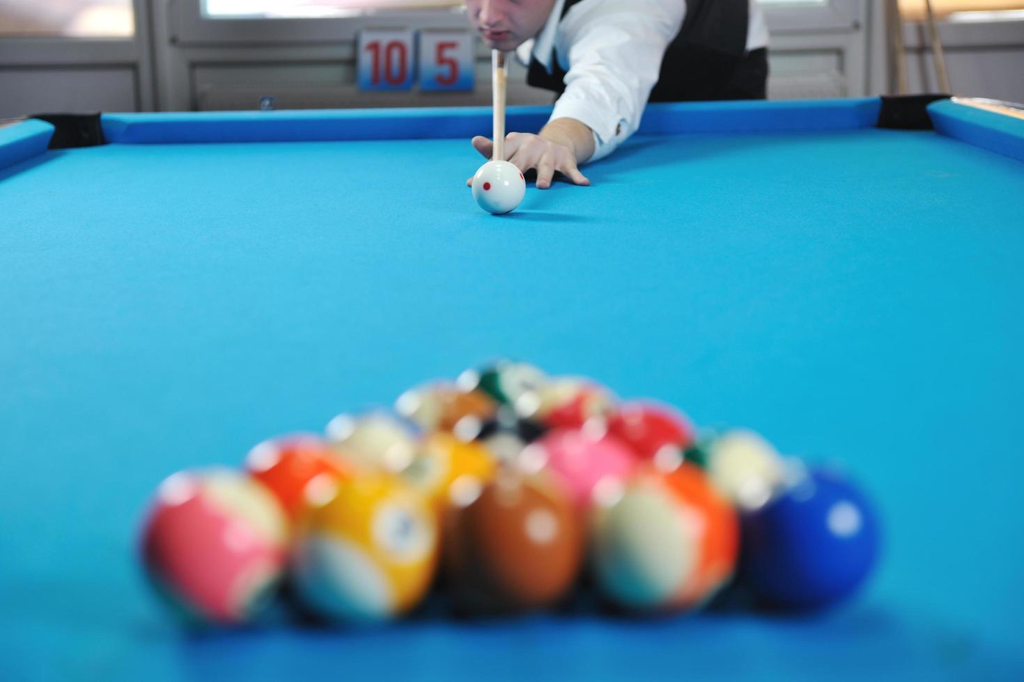 young man play pro billiard game photo