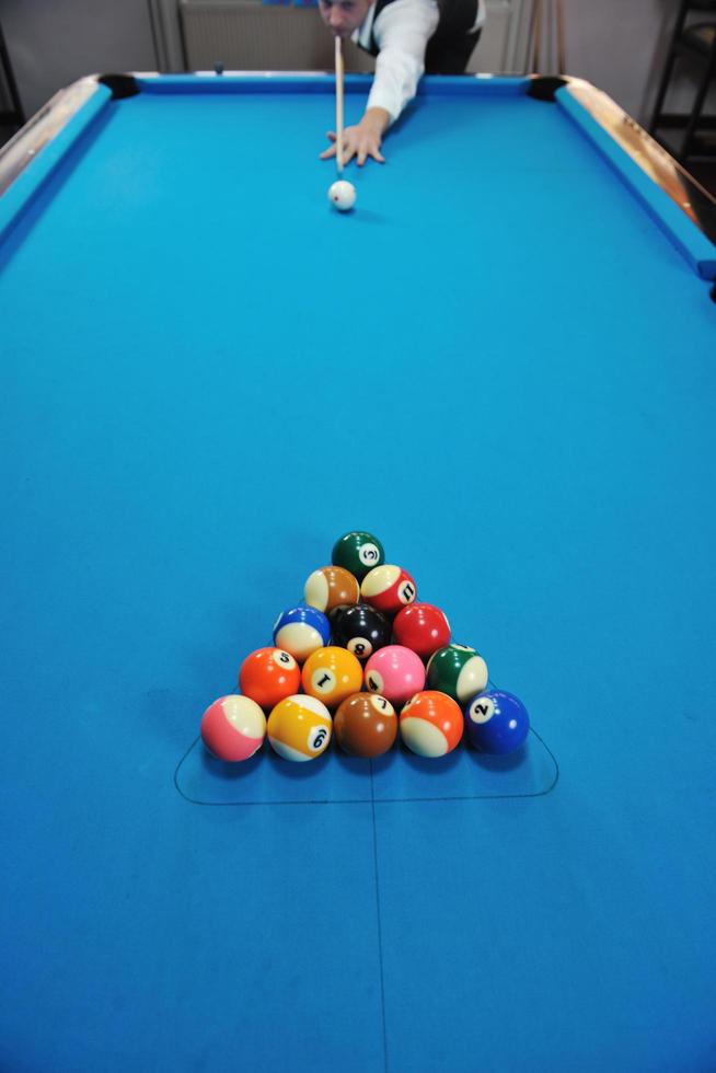 young man play pro billiard game photo