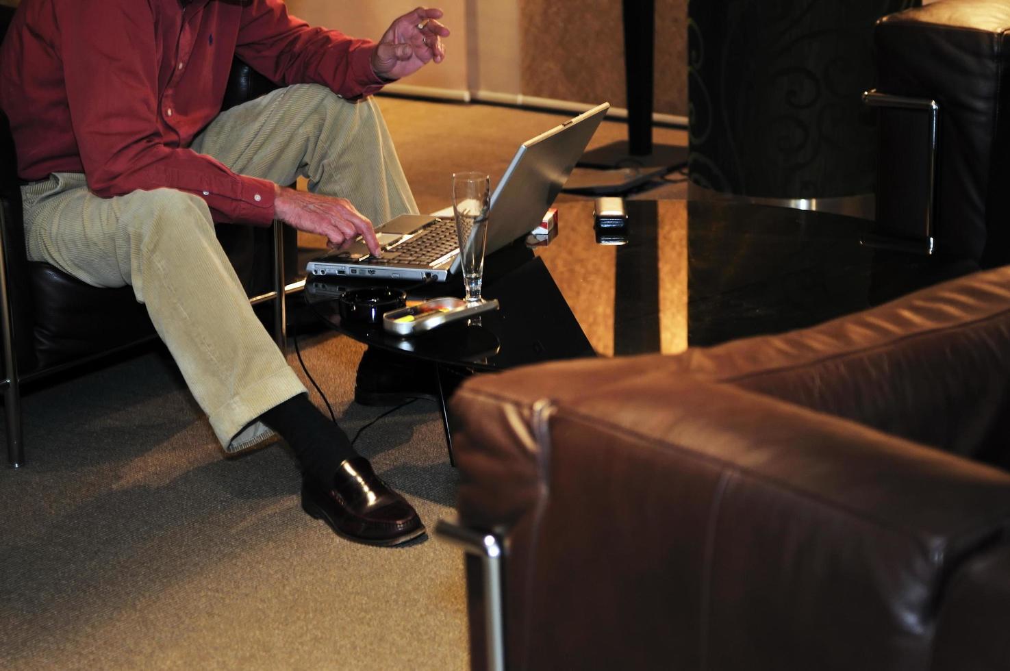 businessman woking on laptop at hotel lobby photo