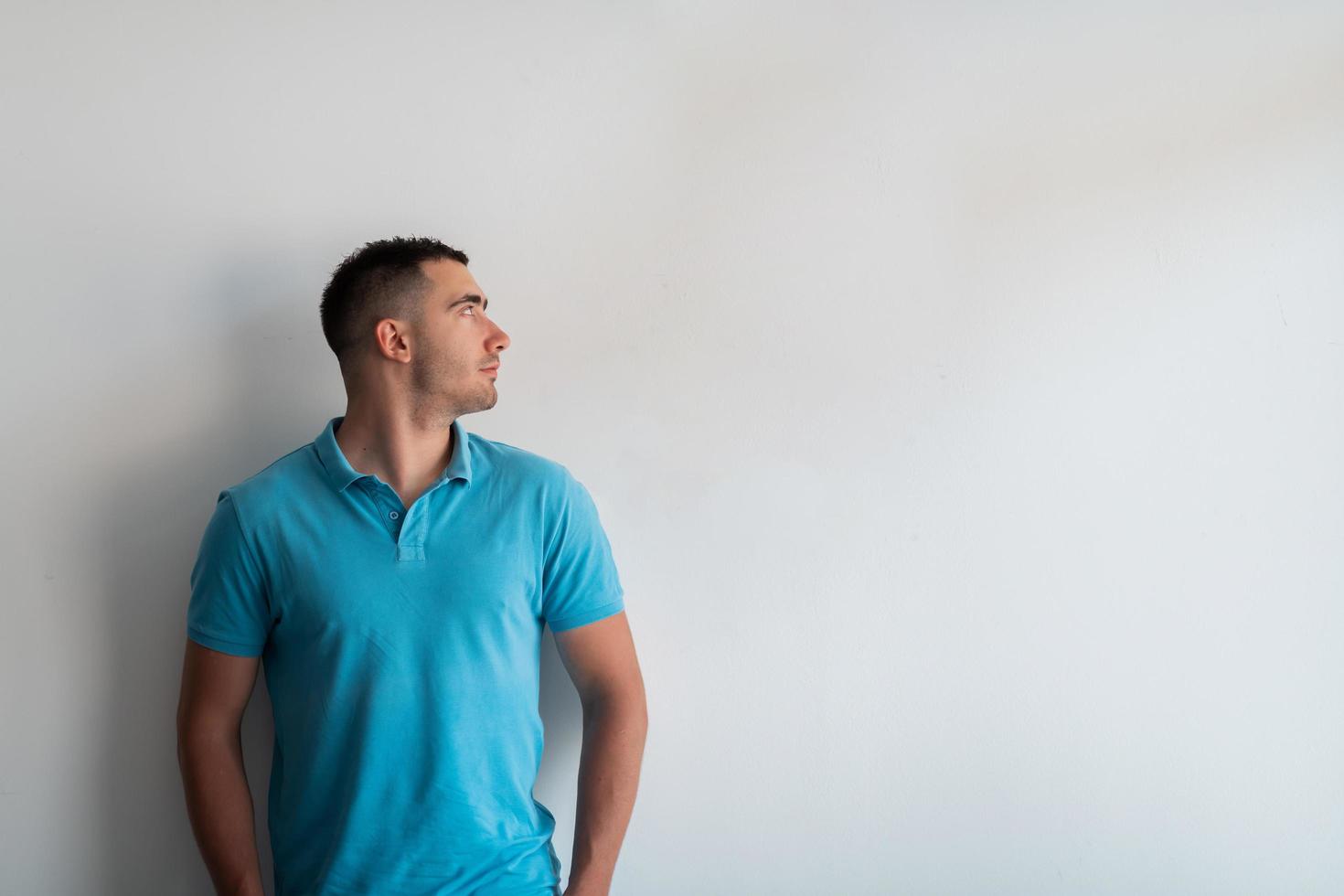 Formal business male portrait. A confident successful casual businessman or manager stands in front of a white background. photo