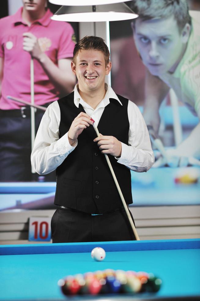 young man play pro billiard game photo