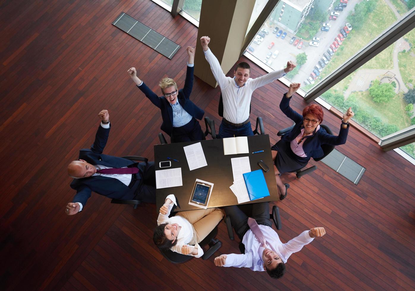 top view of business people group throwing dociments in air photo