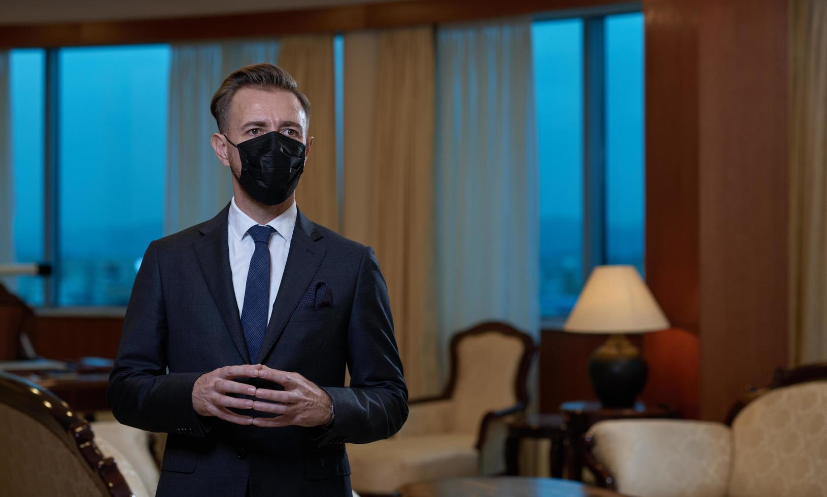 business man wearing protective face mask at office photo