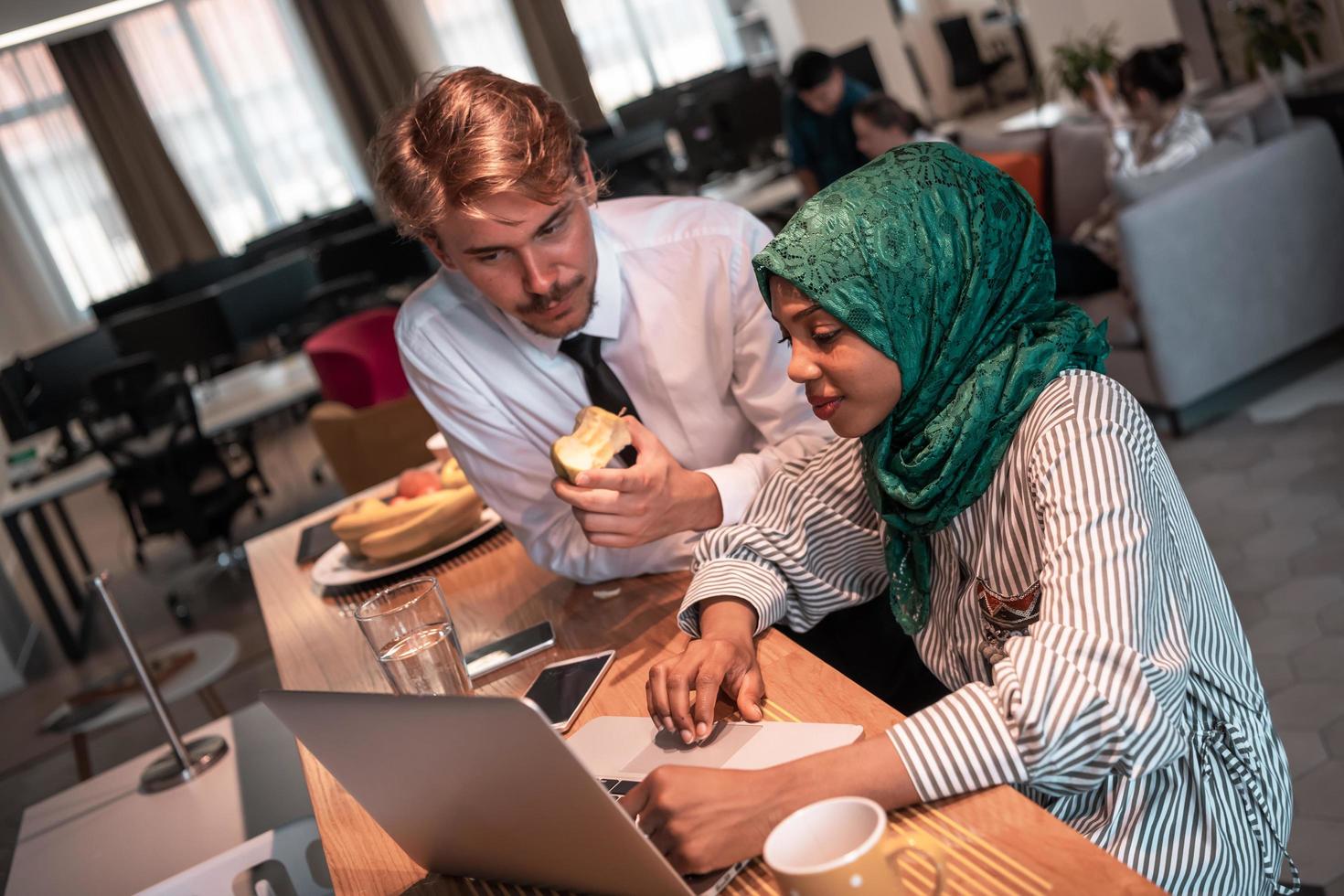 International multicultural business team.A young business man and woman sit in a modern relaxation space and talk about a new business. photo