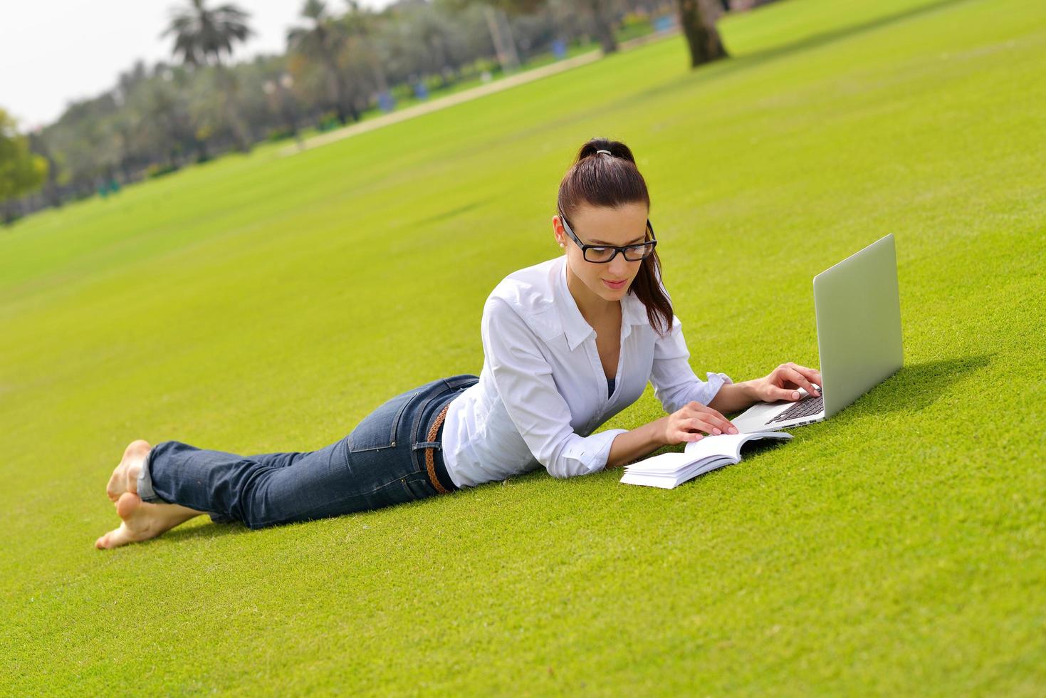 woman with laptop in park photo
