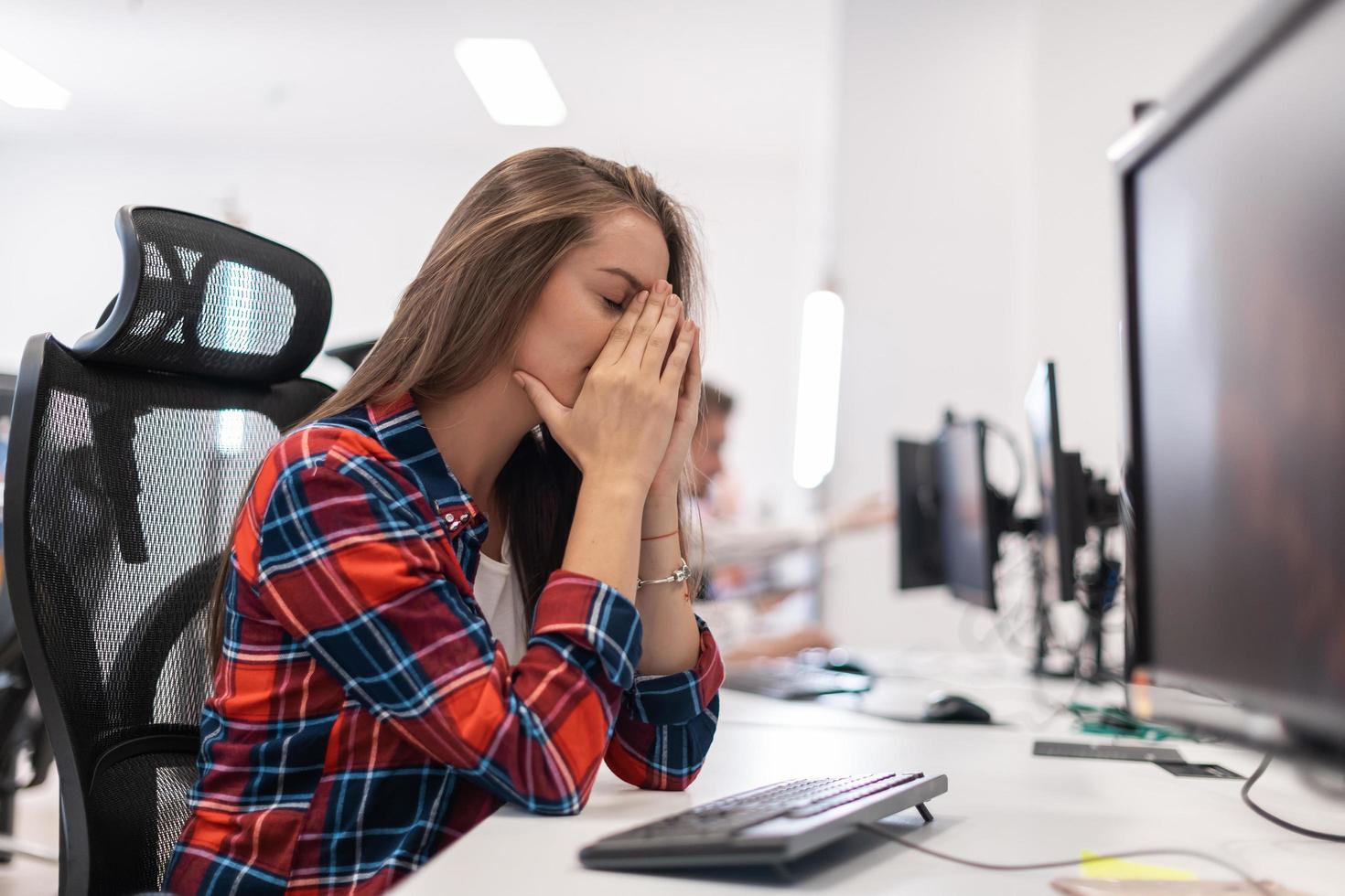 Beautiful Shocked and Annoyed Young Woman Looking her desktop. Sad Operator Agent Woman Working from Home in a Call Center photo