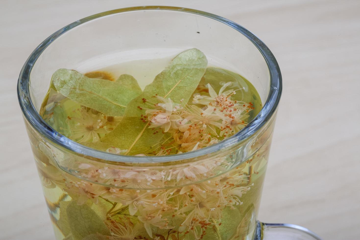Linden tea on wooden background photo