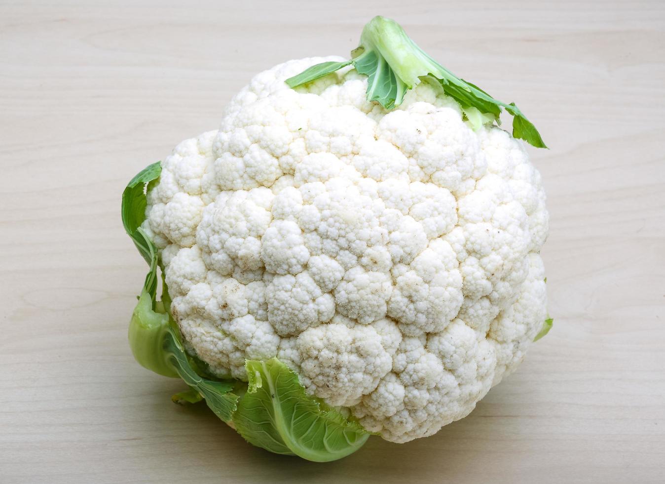 Cauliflower on wooden background photo