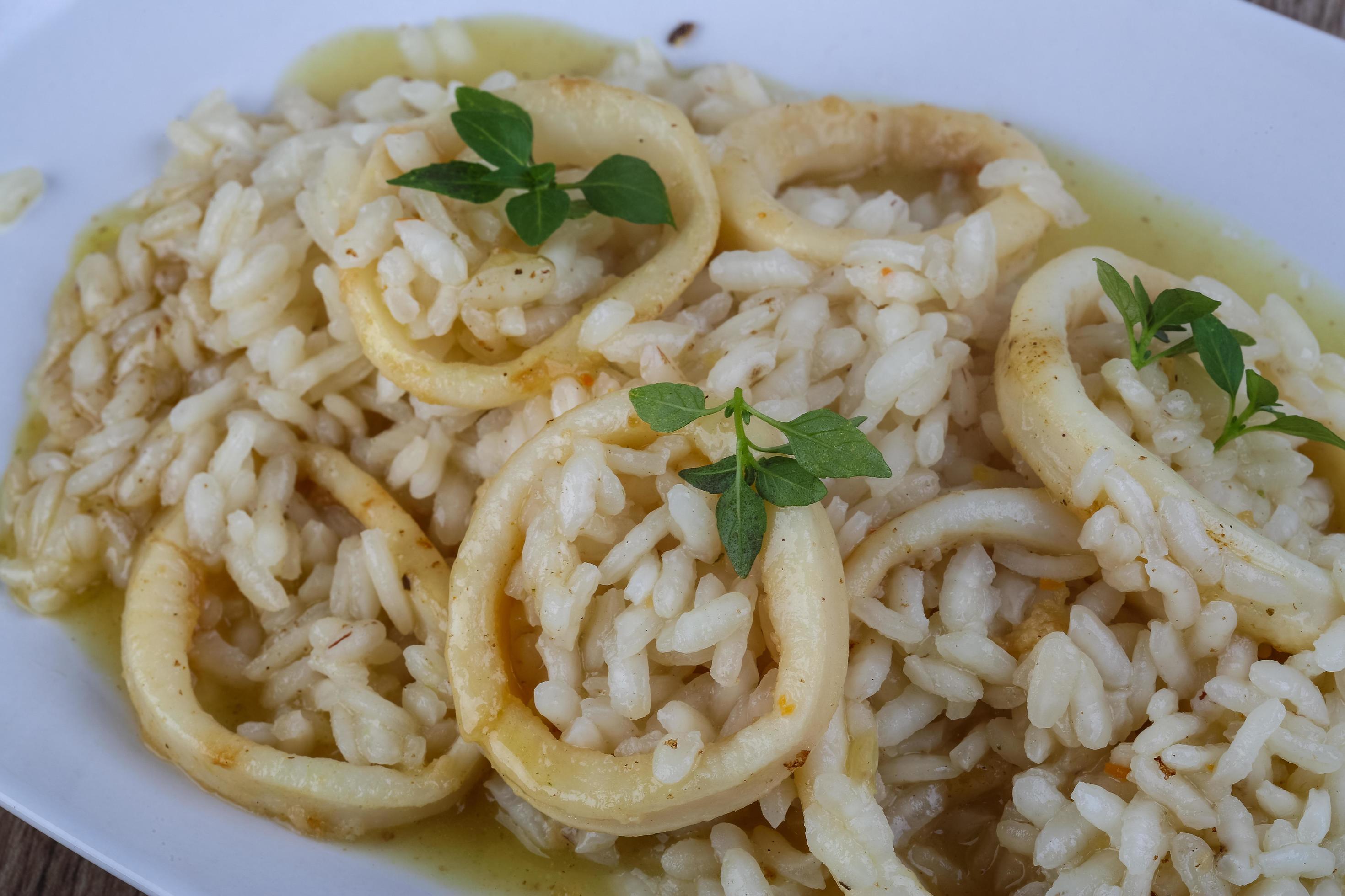 Squid risotto on the plate 12510316 Stock Photo at Vecteezy