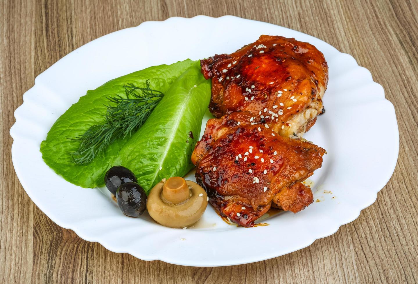 Teriyaki chicken on the plate and wooden background photo