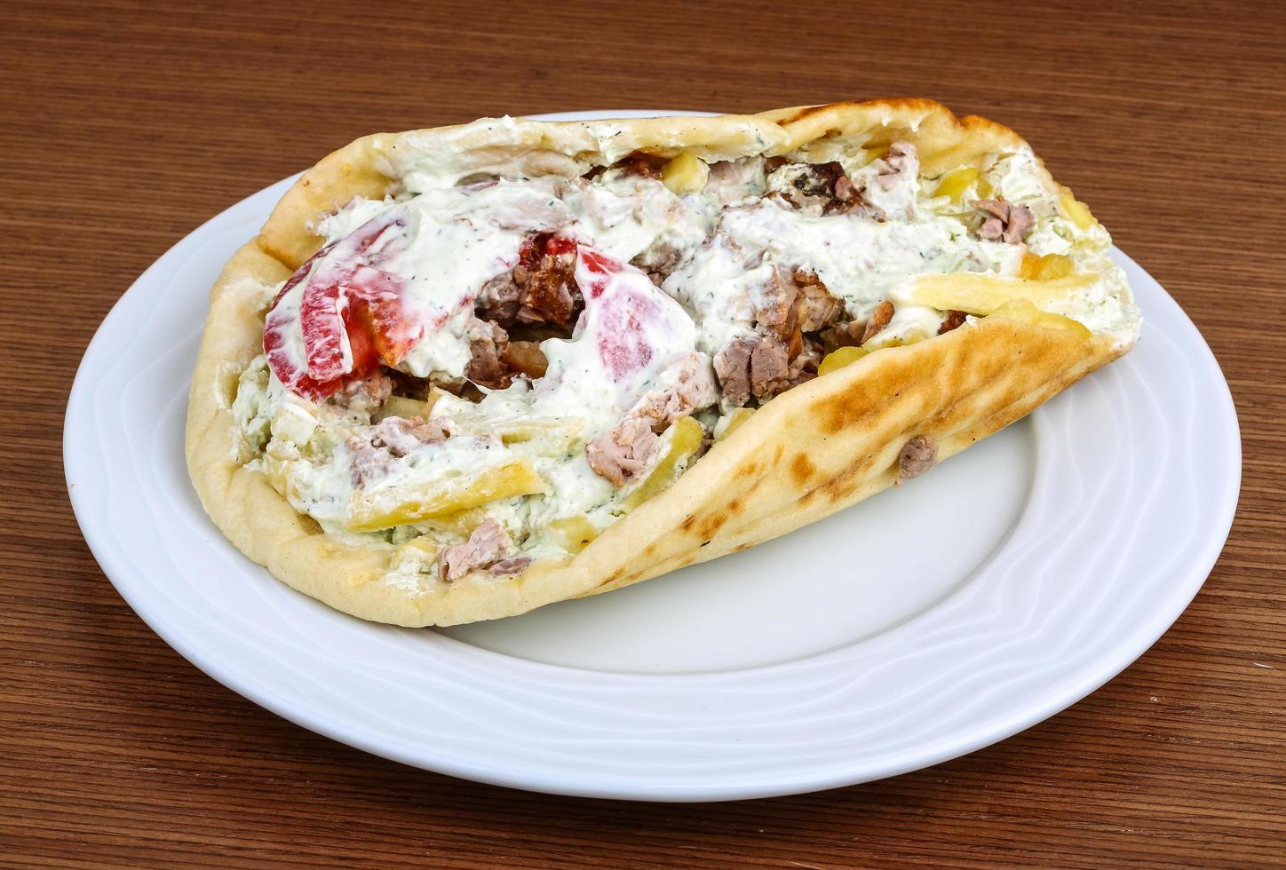 Souvlaki on the plate and wooden background photo